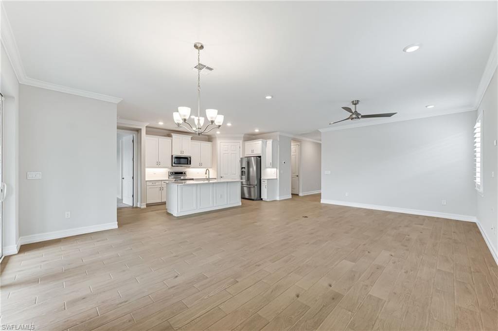 475 Polihale Way Naples, FL 34114 - Photo 5 of 27 a view of a kitchen with a sink and a chandelier