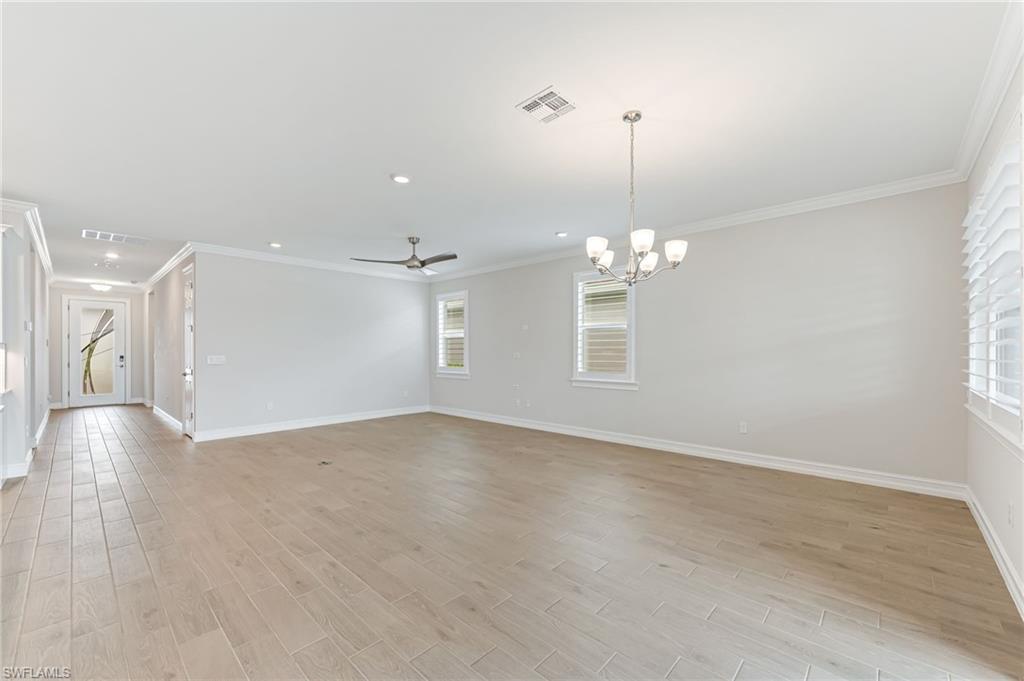 475 Polihale Way Naples, FL 34114 - Photo 6 of 27 a view of a room with chandelier fan and windows