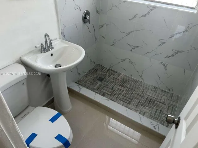 a bathroom with a toilet and a sink