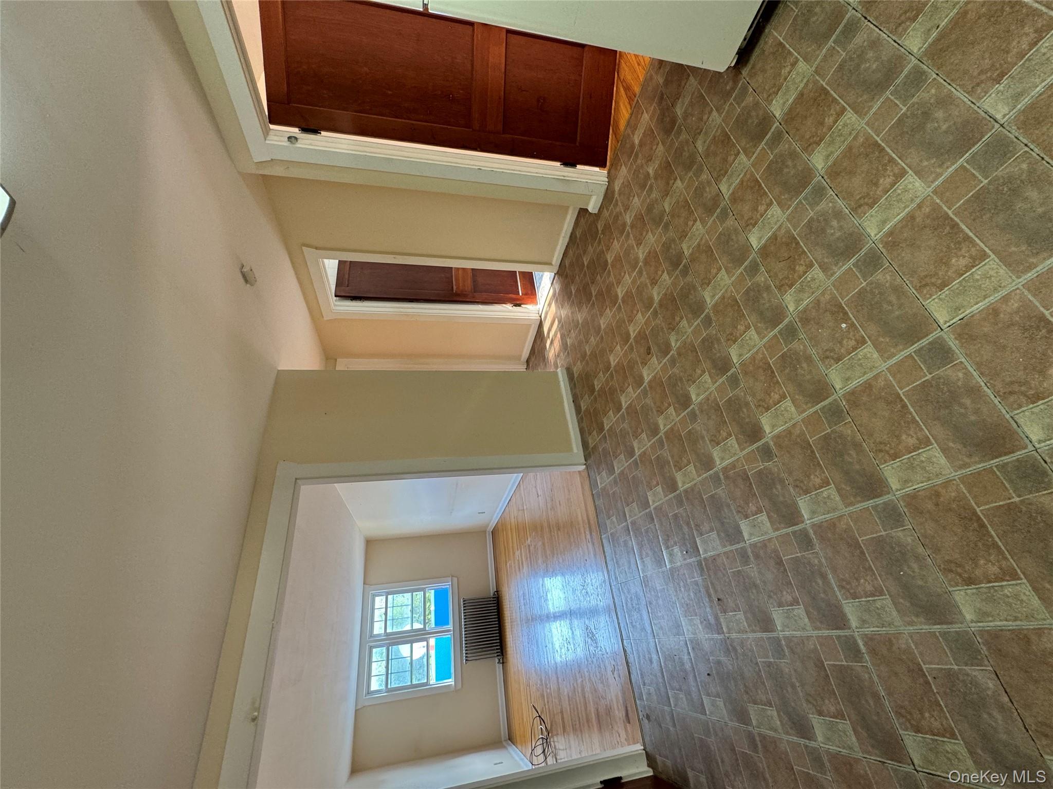 560 State Rte 44 55, Unit D Highland, NY 12528 - Photo 13 of 13 Unfurnished living room featuring radiator heating unit and baseboards