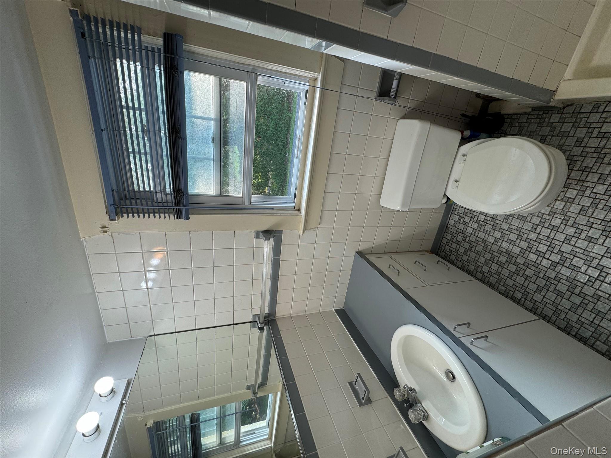 560 State Rte 44 55, Unit D Highland, NY 12528 - Photo 6 of 13 Full bath with tile walls, vanity, and tile patterned flooring