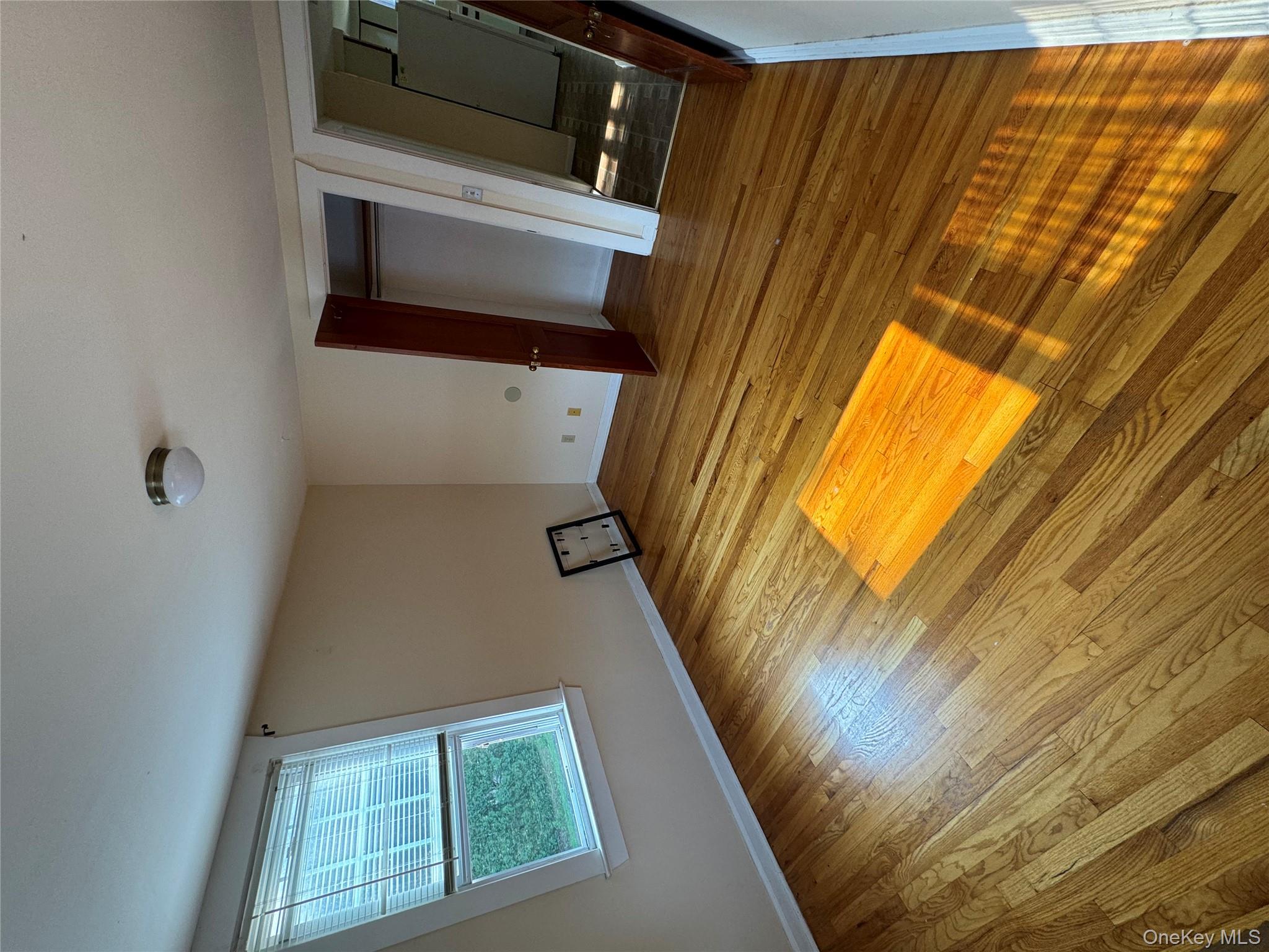 560 State Rte 44 55, Unit D Highland, NY 12528 - Photo 9 of 13 Unfurnished bedroom featuring refrigerator, light wood-style flooring, and a closet