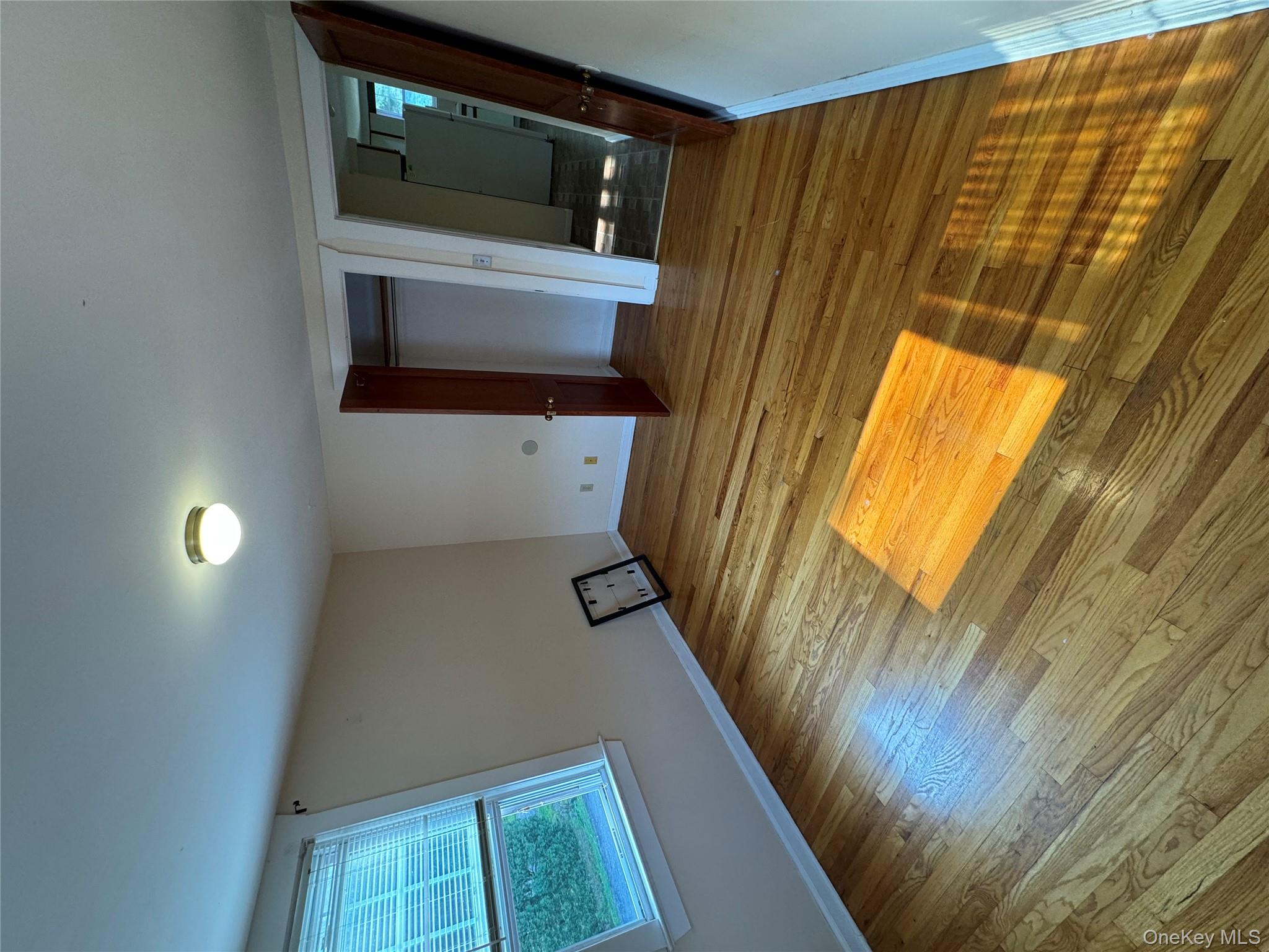 560 State Rte 44 55, Unit D Highland, NY 12528 - Photo 10 of 13 Unfurnished bedroom featuring a closet, wood finished floors, and refrigerator
