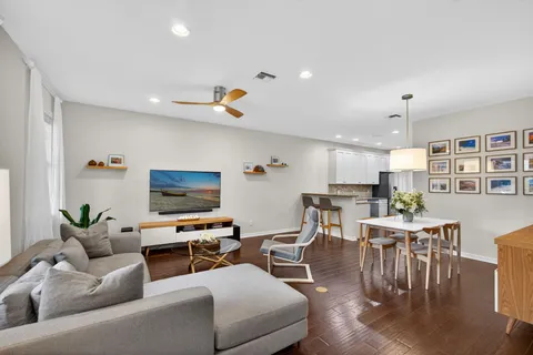 a living room with furniture and kitchen view