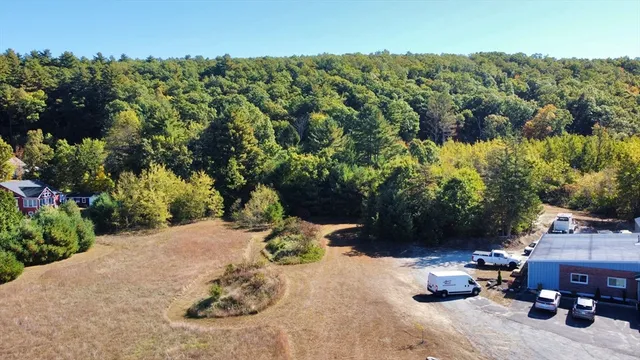a view of a backyard with table and chairs plants