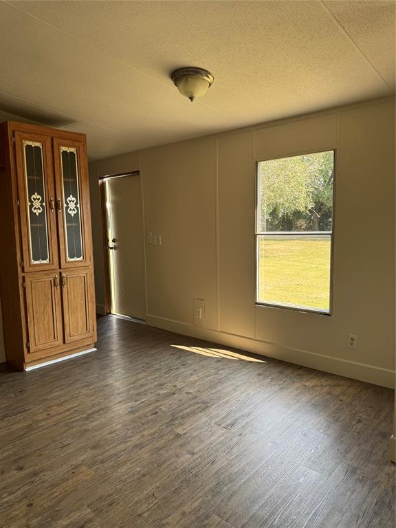 201 Donna Street Alvarado, TX 76009 - Photo 4 of 14 a view of an empty room with a window and wooden floor