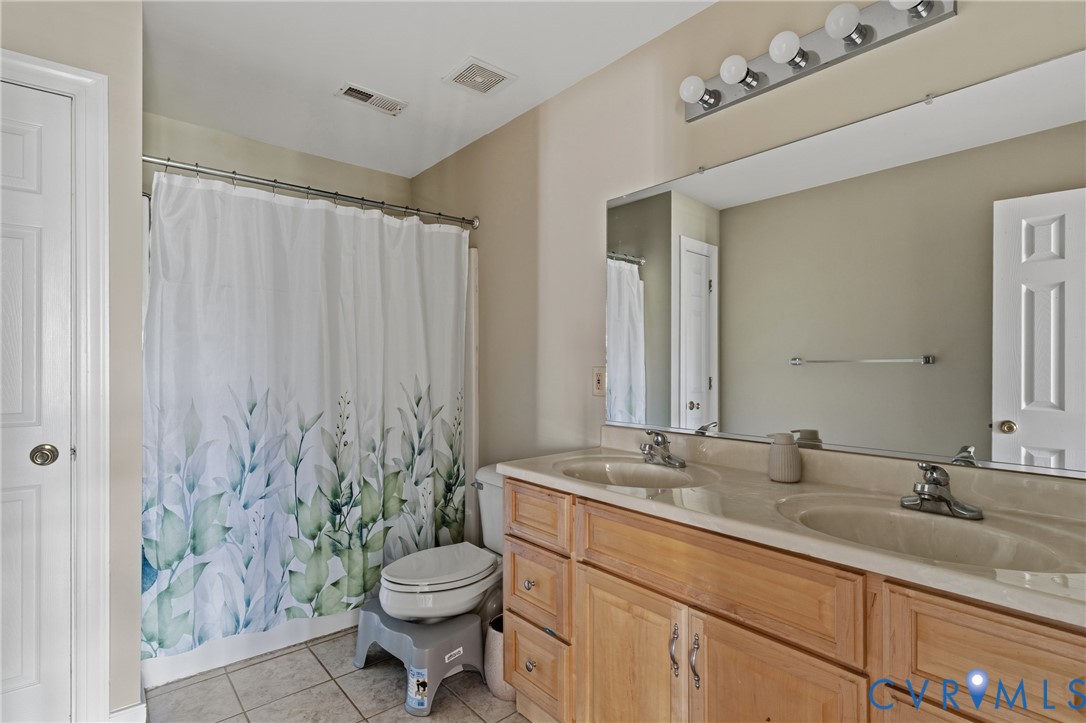 15286 Devonwood Road Montpelier, VA 23192 - Photo 42 of 50 Bathroom featuring double vanity, curtained shower