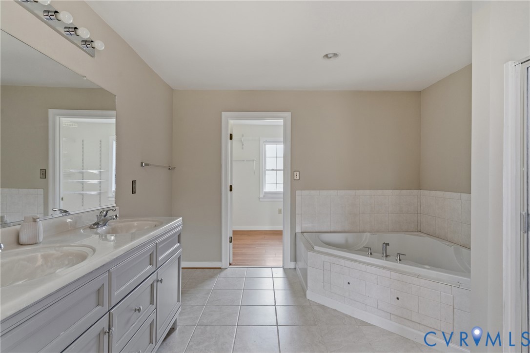 15286 Devonwood Road Montpelier, VA 23192 - Photo 47 of 50 Bathroom with double vanity, a bath, and light til