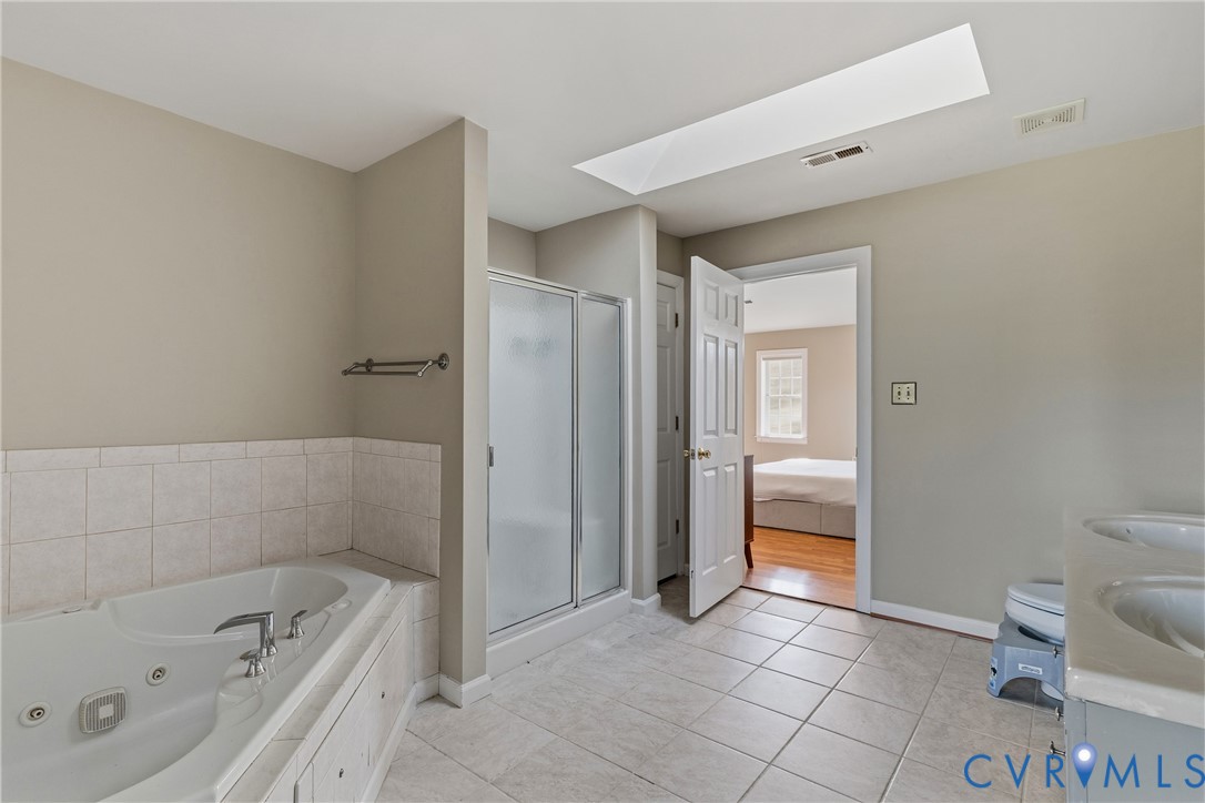 15286 Devonwood Road Montpelier, VA 23192 - Photo 48 of 50 Ensuite bathroom with a skylight, double vanity, a
