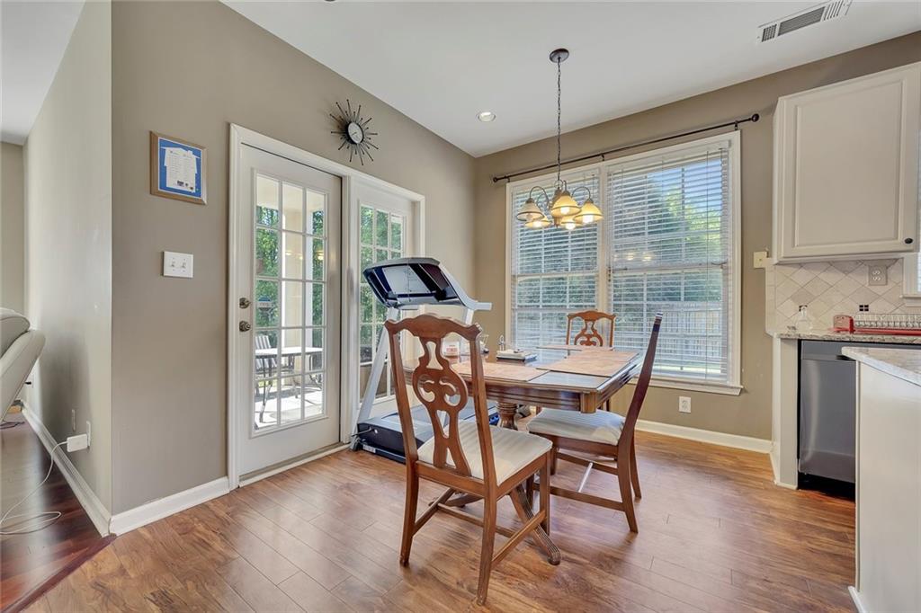 785 Hedgewick Trail Alpharetta, GA 30022 - Photo 12 of 32 a dining room with furniture large windows and wooden floor
