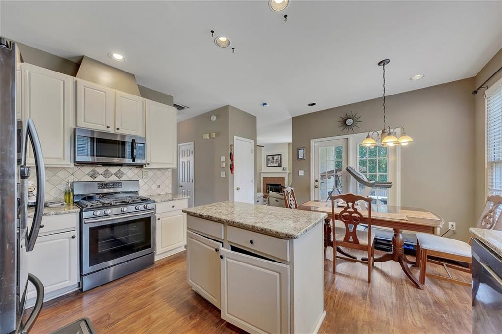 785 Hedgewick Trail Alpharetta, GA 30022 - Photo 16 of 32 a kitchen with a stove a sink and a refrigerator