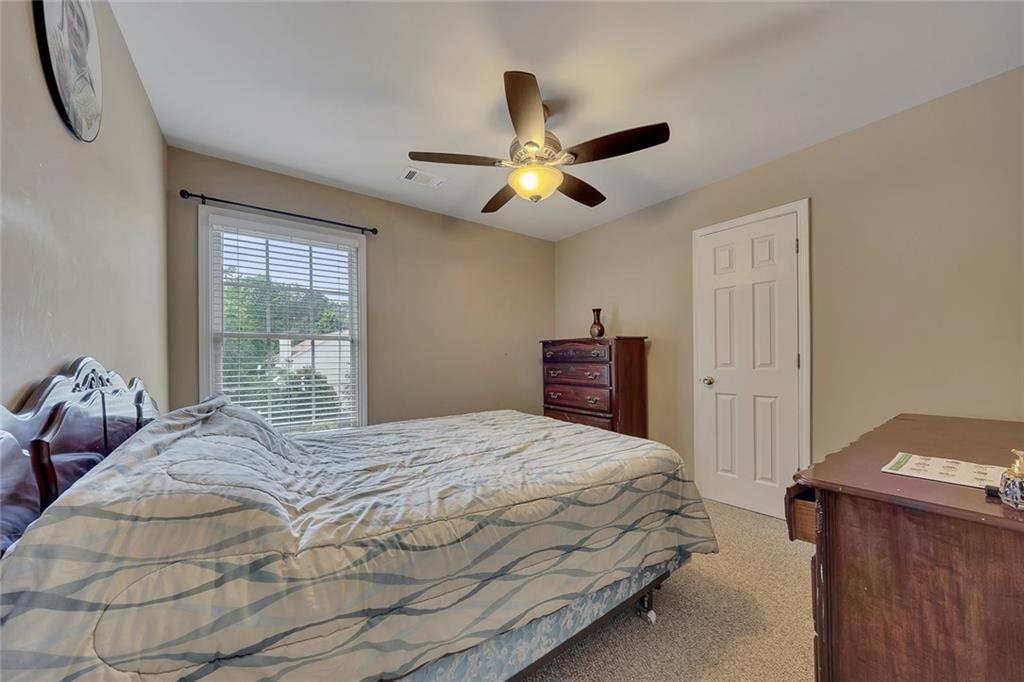 785 Hedgewick Trail Alpharetta, GA 30022 - Photo 18 of 32 a bedroom with a bed and window
