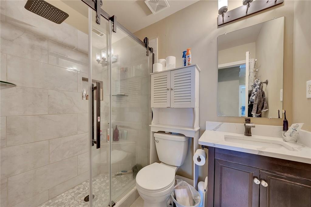 785 Hedgewick Trail Alpharetta, GA 30022 - Photo 19 of 32 a bathroom with a toilet a sink and shower