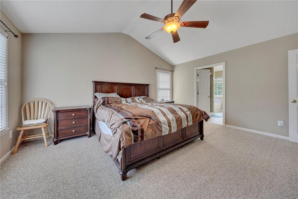 785 Hedgewick Trail Alpharetta, GA 30022 - Photo 21 of 32 a bedroom with a bed and a chandelier