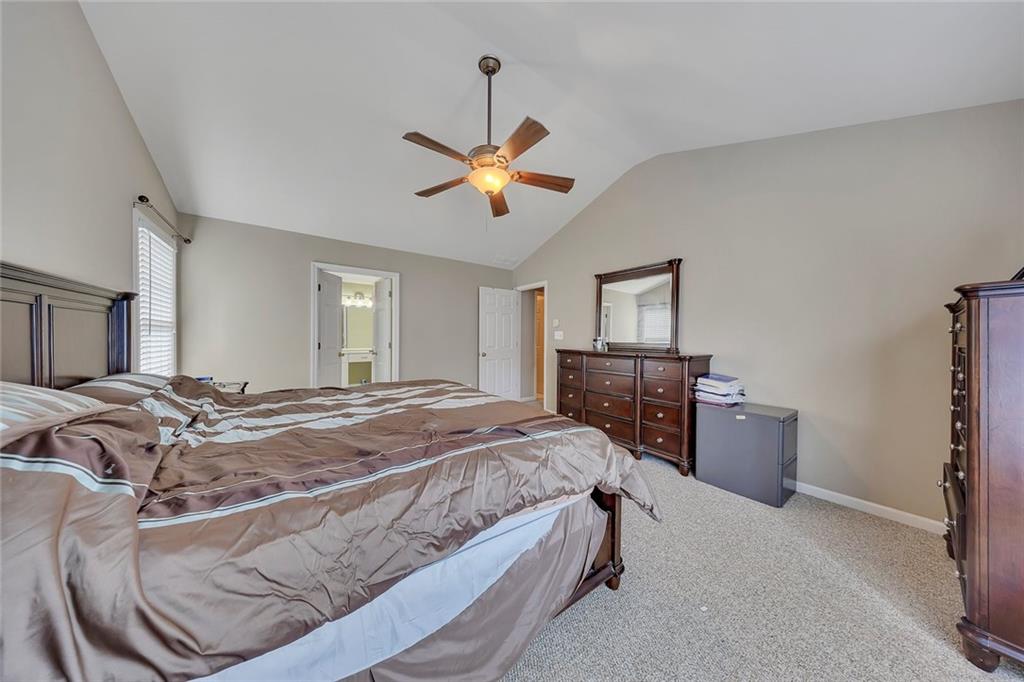 785 Hedgewick Trail Alpharetta, GA 30022 - Photo 22 of 32 a bed room with a bed and a chandelier