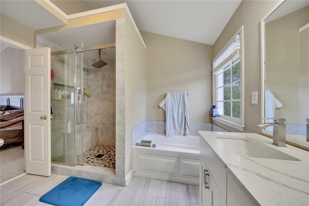 785 Hedgewick Trail Alpharetta, GA 30022 - Photo 24 of 32 a bathroom with a tub sink and mirror