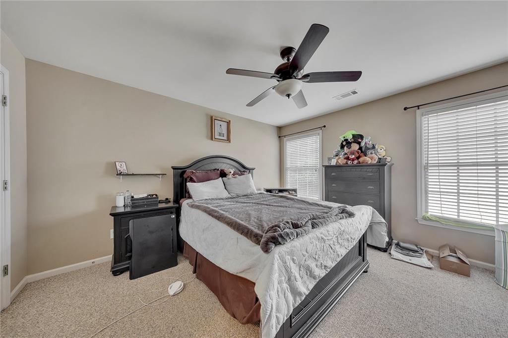785 Hedgewick Trail Alpharetta, GA 30022 - Photo 27 of 32 a bedroom with a bed and a chandelier
