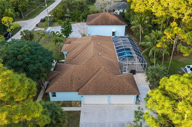 an aerial view of a house with a yard and balcony
