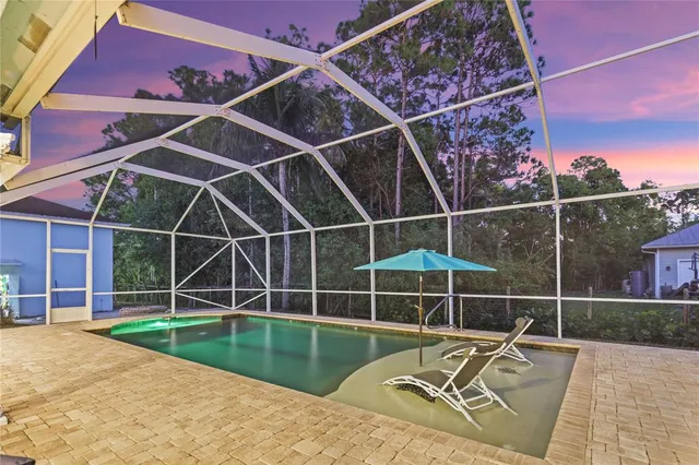 a view of a backyard with a table and chair
