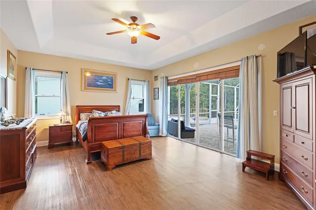 a living room with furniture and a flat screen tv with wooden floor