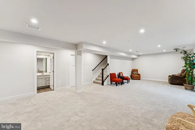 an empty room with furniture and white walls