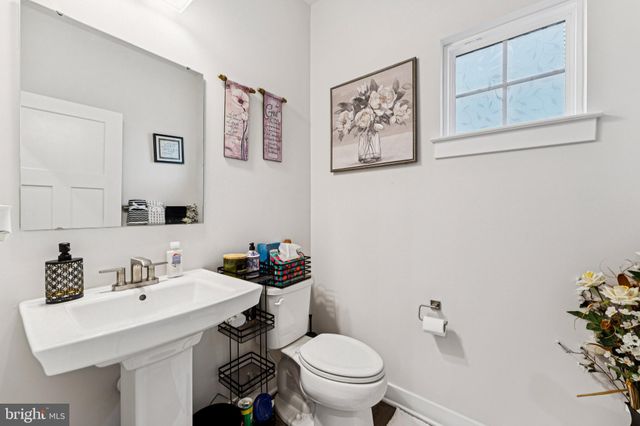 a bathroom with a sink mirror and toilet