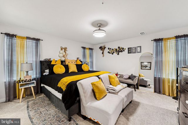 a bedroom with bed and wooden floor