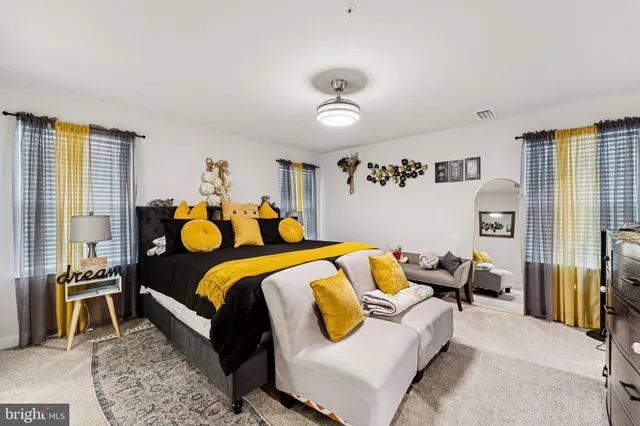 a bedroom with bed and wooden floor