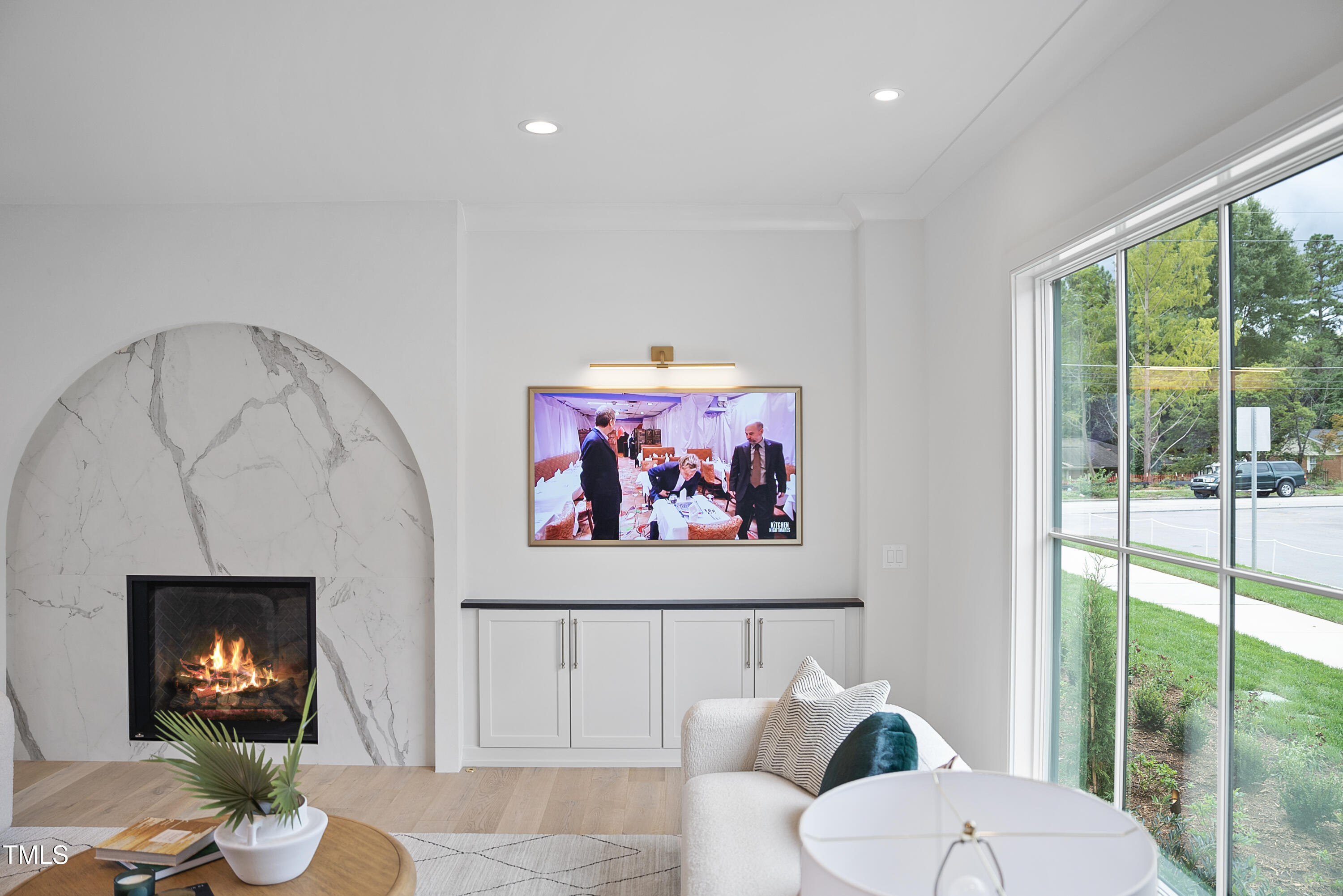 3300 Founding Place Raleigh, NC 27612 - Photo 88 of 100 a living room with furniture a floor to ceiling window and a flat screen tv