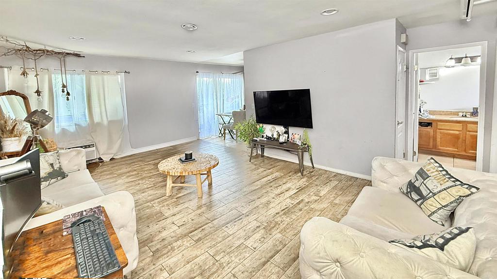 10235 Madrid Way, Unit 114 Spring Valley, CA 91977 - Photo 1 of 19 a bedroom with a bed and a flat screen tv