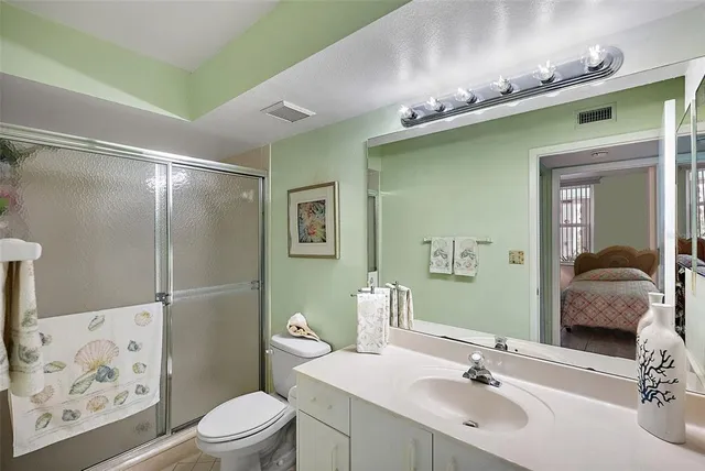 a bathroom with a sink mirror and toilet