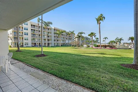 a view of a big building with a big yard and plants