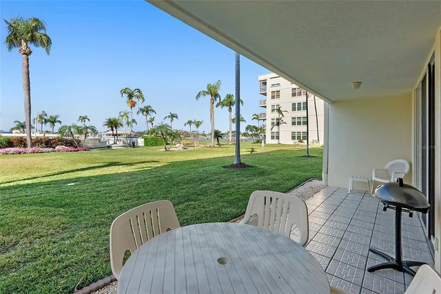 a view of a chair and table on the deck