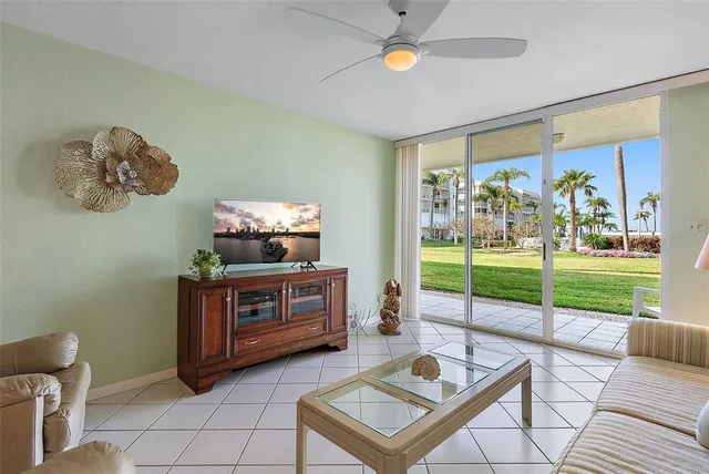 a living room with couch and a floor to ceiling window