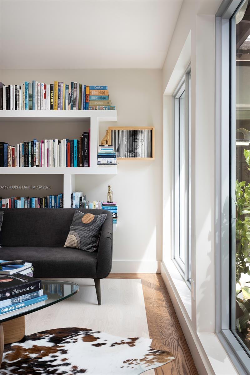 4140 Battersea Road Coconut Grove, FL 33133 - Photo 11 of 37 a living room with furniture and a book shelf