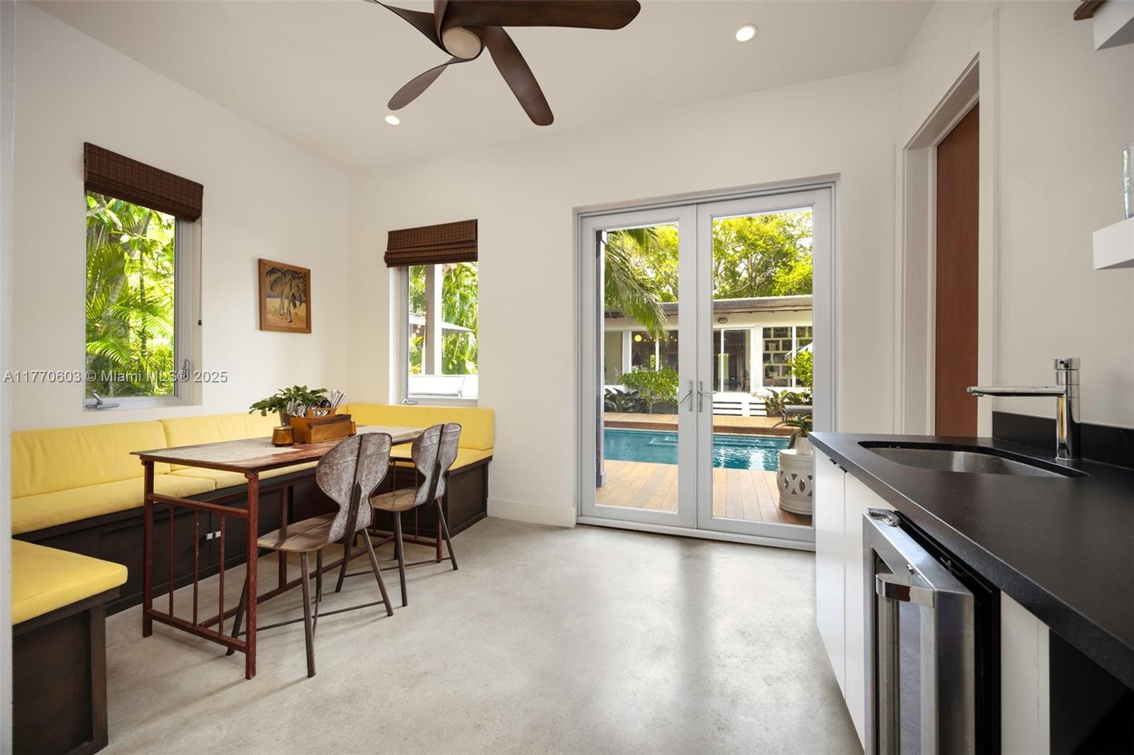 4140 Battersea Road Coconut Grove, FL 33133 - Photo 12 of 37 a view of a dining room with furniture and a window