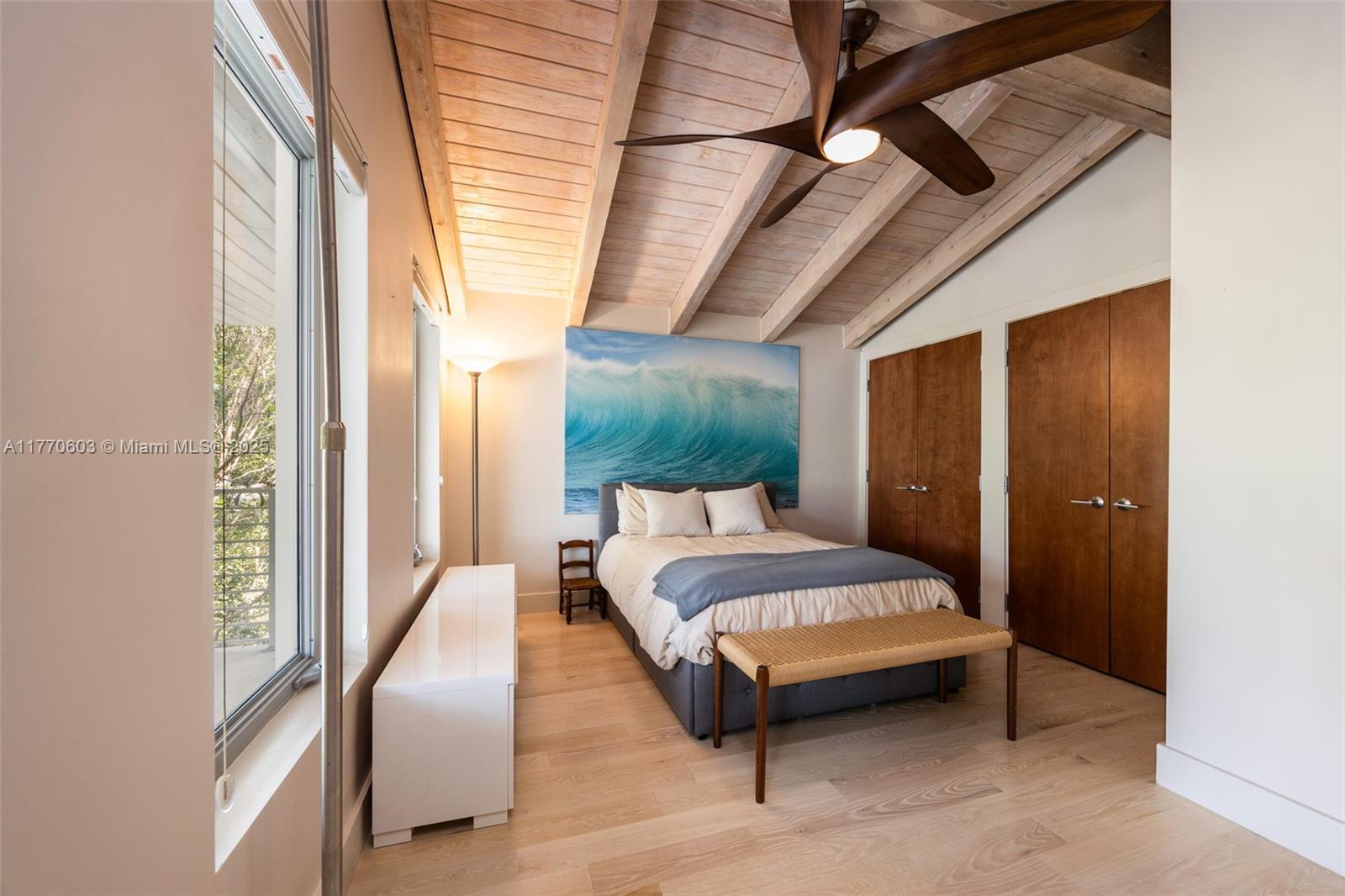 4140 Battersea Road Coconut Grove, FL 33133 - Photo 19 of 37 a spacious bedroom with a bed wooden floor and window