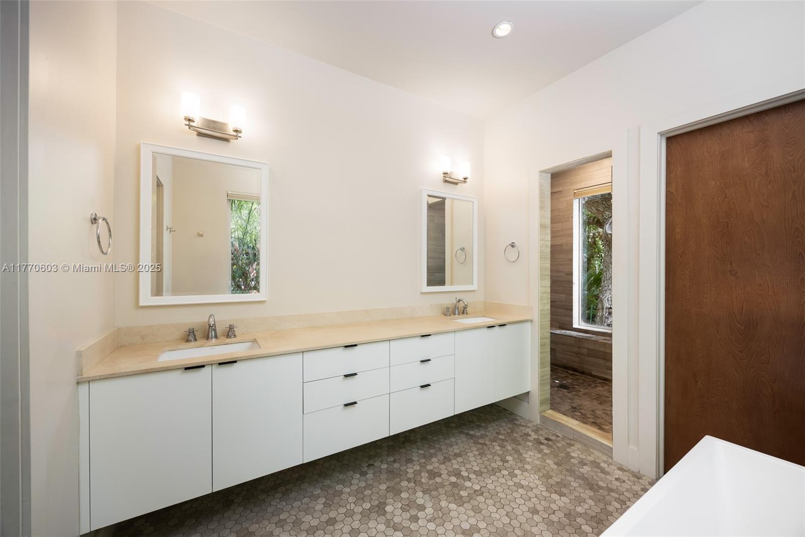 4140 Battersea Road Coconut Grove, FL 33133 - Photo 23 of 37 a bathroom with a granite countertop sink and a mirror