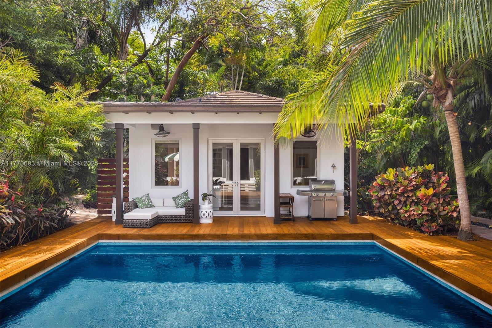 4140 Battersea Road Coconut Grove, FL 33133 - Photo 33 of 37 a view of swimming pool with lawn chairs and large trees