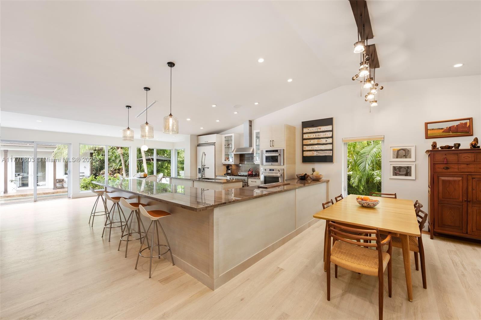 4140 Battersea Road Coconut Grove, FL 33133 - Photo 5 of 37 a large kitchen with a table and chairs