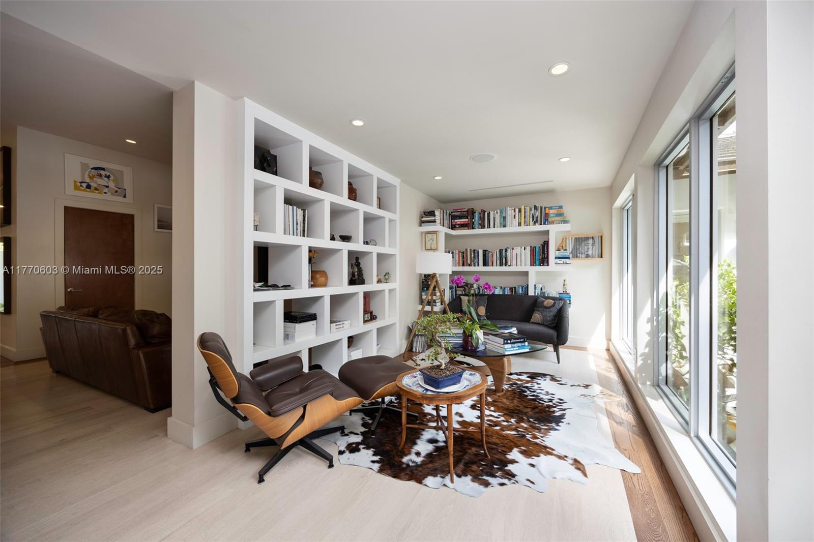 4140 Battersea Road Coconut Grove, FL 33133 - Photo 10 of 37 a living room with furniture and a book shelf