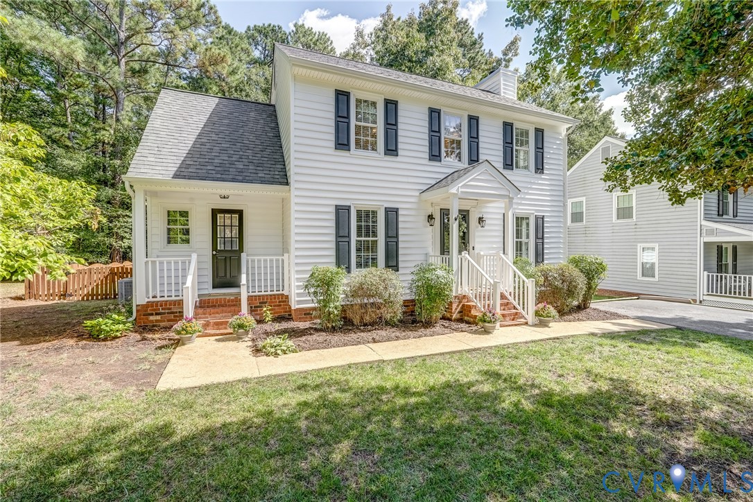 a front view of a house with a yard and seating space