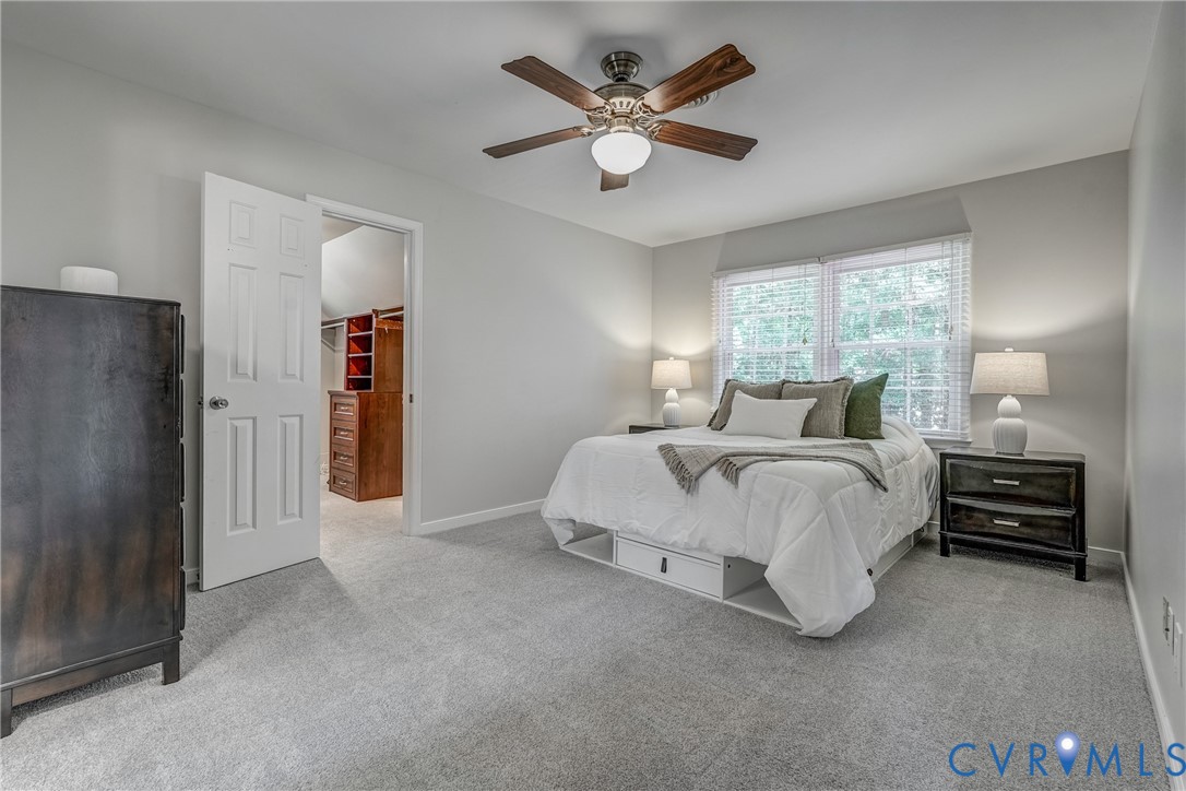 5016 Eddings Drive Glen Allen, VA 23060 - Photo 12 of 22 a spacious bedroom with a bed and a chandelier