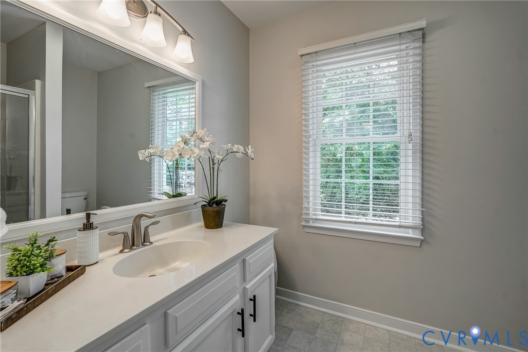 5016 Eddings Drive Glen Allen, VA 23060 - Photo 14 of 22 a bathroom with a sink and a mirror