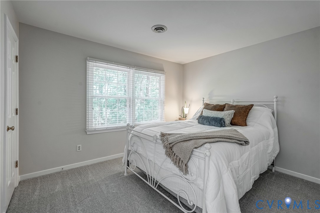 5016 Eddings Drive Glen Allen, VA 23060 - Photo 15 of 22 a bed sitting in a bedroom next to a window