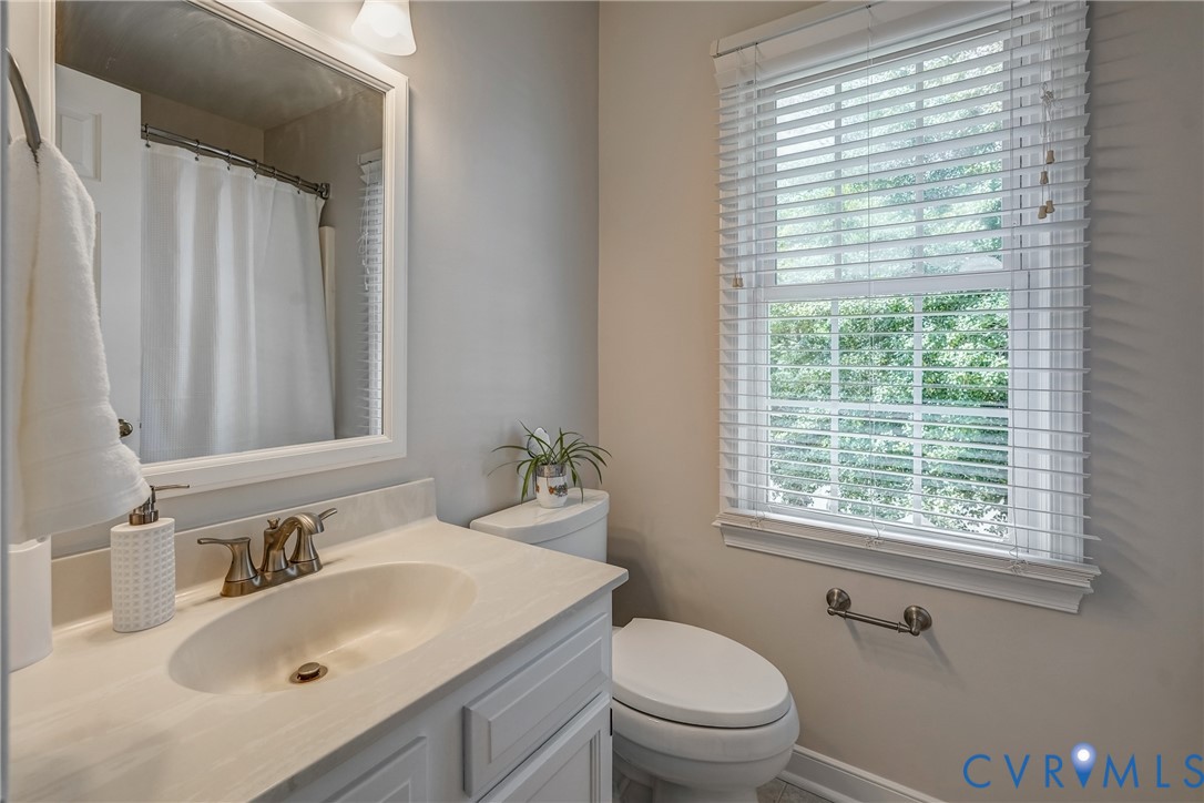 5016 Eddings Drive Glen Allen, VA 23060 - Photo 17 of 22 a bathroom with a sink toilet a mirror and a window