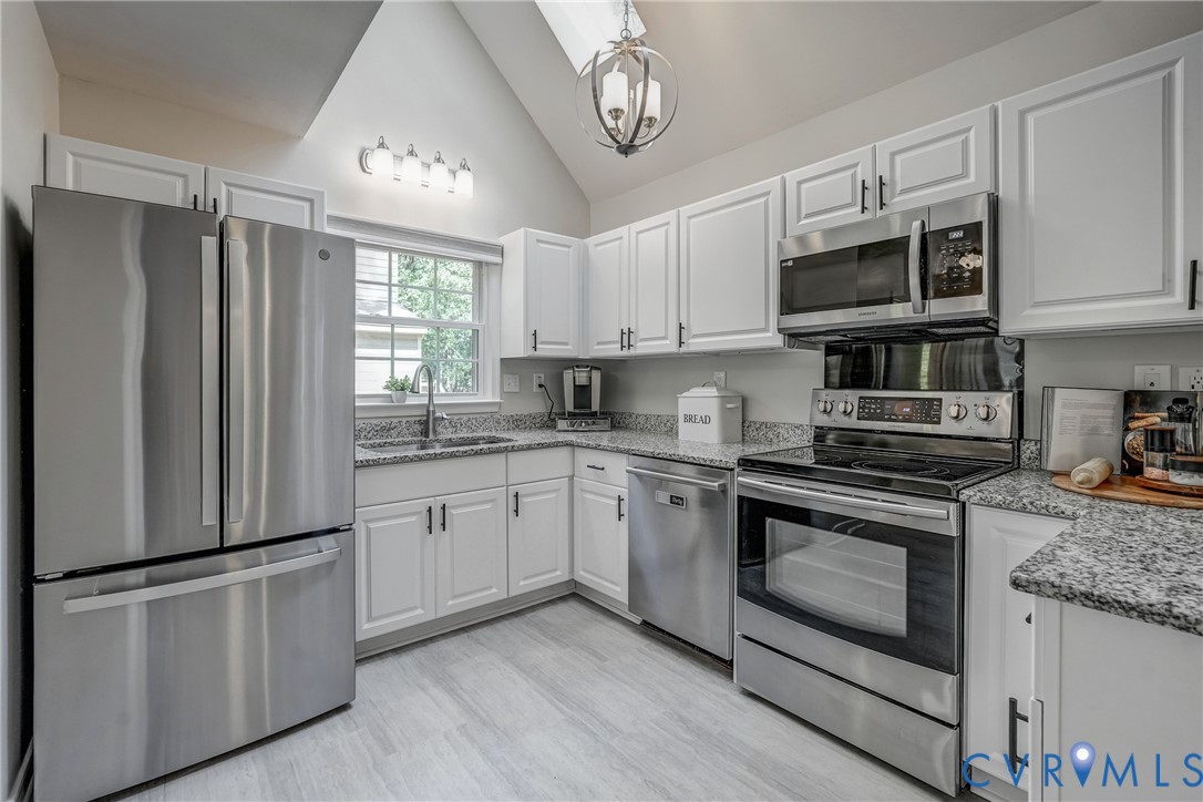 5016 Eddings Drive Glen Allen, VA 23060 - Photo 5 of 22 a kitchen with stainless steel appliances granite countertop a refrigerator a stove a sink and a microwave