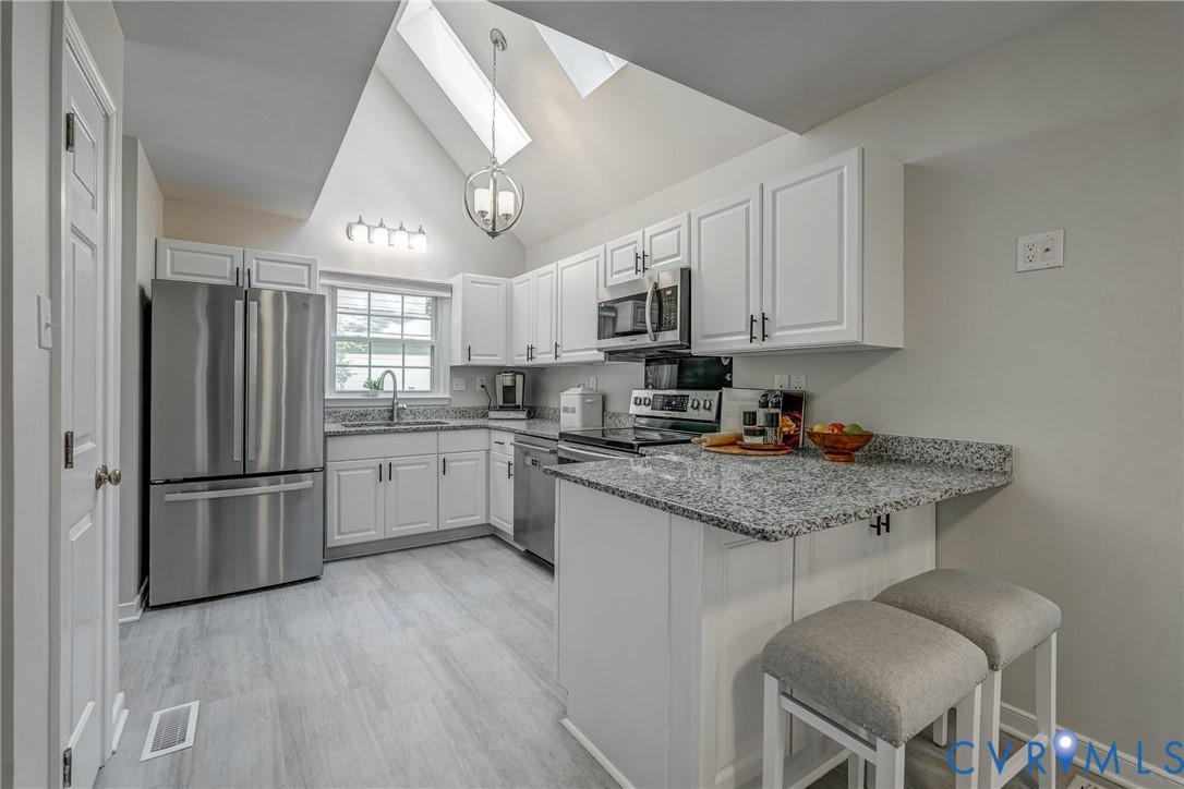 5016 Eddings Drive Glen Allen, VA 23060 - Photo 6 of 22 a kitchen with stainless steel appliances granite countertop a white cabinets and a refrigerator