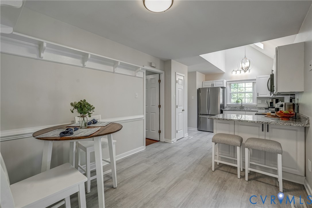 5016 Eddings Drive Glen Allen, VA 23060 - Photo 7 of 22 a kitchen with stainless steel appliances a dining table chairs and entryway
