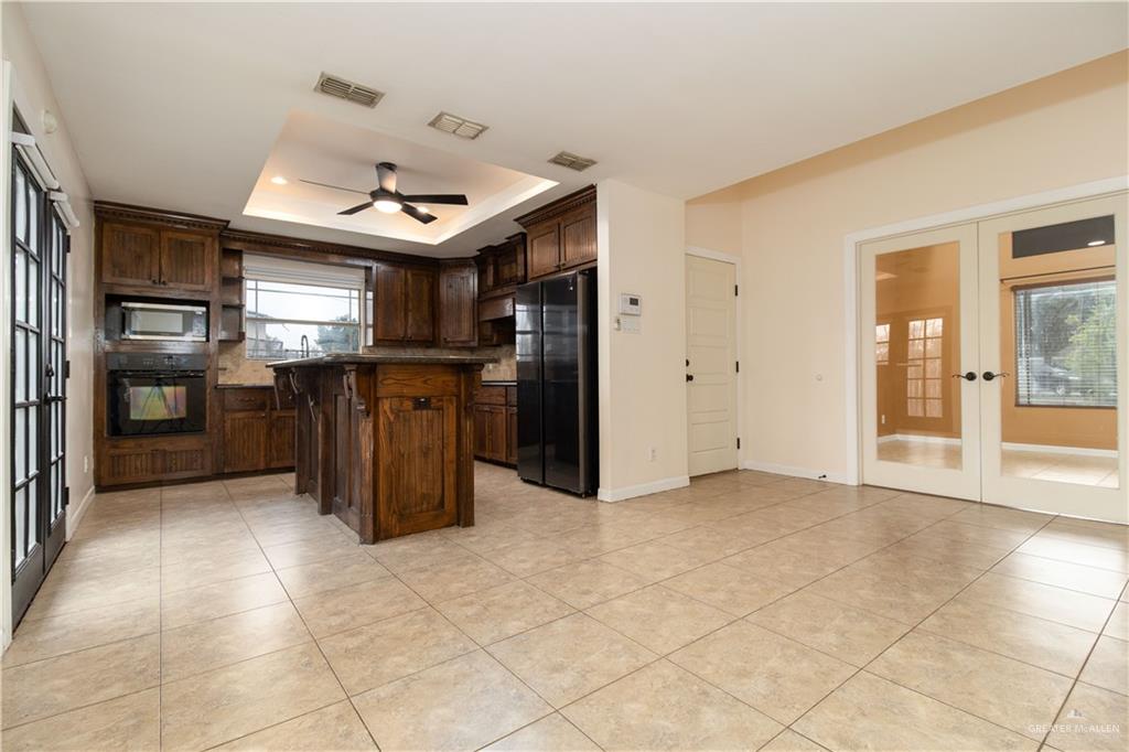 8907 North 36th Lane McAllen, TX 78504 - Photo 7 of 16 a kitchen with stainless steel appliances granite countertop a refrigerator and a sink